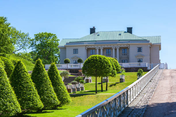 Red building facades surrounded by green foliage during spring in stockholm, sweden