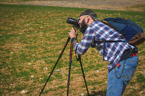 Photographer takes pictures with the camera. The woman takes pictures on the camera.