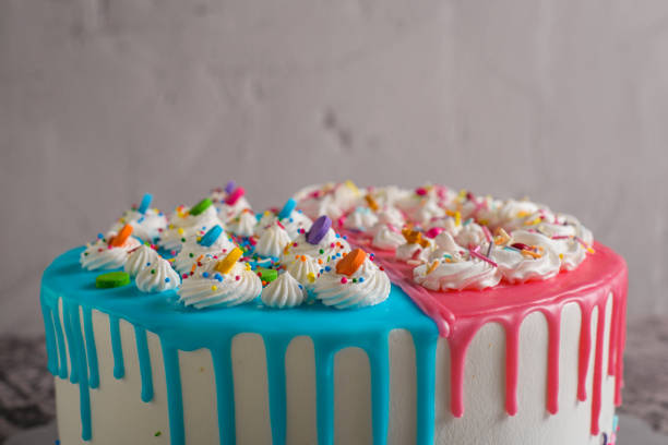 istock Very colorful cake decorated with blue and pink icing on a cement table. 1481317262