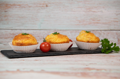 Savory muffin with ham and cheese on blue background, High quality photo