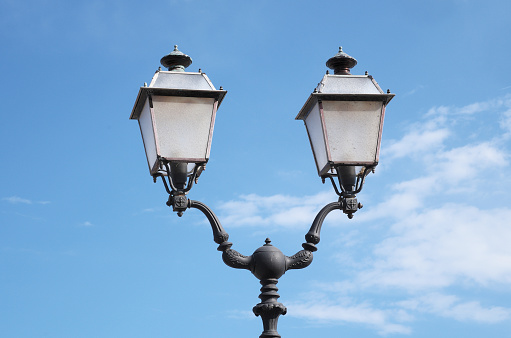 historic wrought iron street lamps that illuminate the streets of Tuscan villages