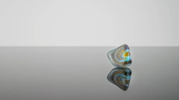 istock Polished strata rock crystal with its reflection against a grey background. 1481319854