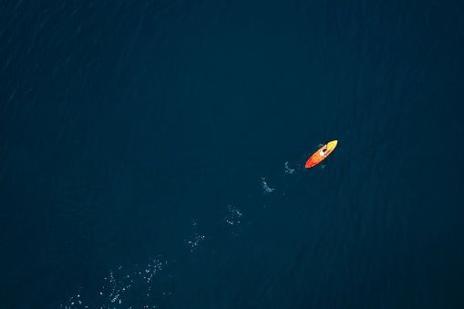 Aerial view on woman kayaking in blue sea of Hvar Island, Croatia.