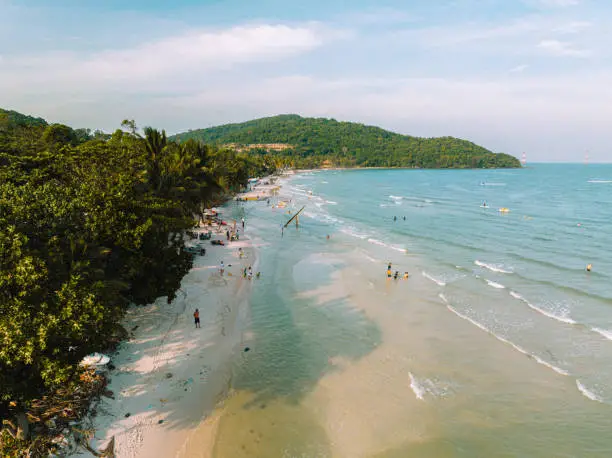 Famous Khem Beach - Bãi tắm Khem in the South of Phú Quốc Island. Tourists and Travellers swimming and sunbathing, relaxing in their vacation at the famous south-eastern beach of Phu Quoc. Khem Beach, Phú Quốc Island, South Vietnam, Southeast Asia.