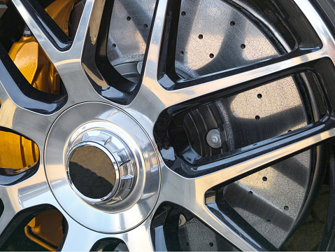 Carbon disc brake behind aluminum rim. detailed photo of the carbon disc brake. Fine cracks and structures can be seen