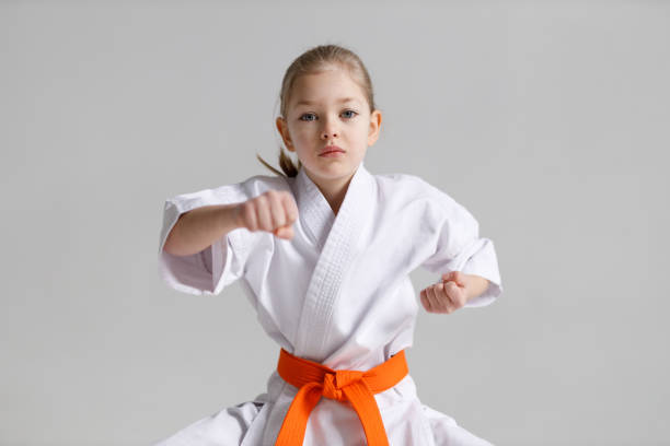 istock Child girl in a protective karate position on a white background. 1481328147