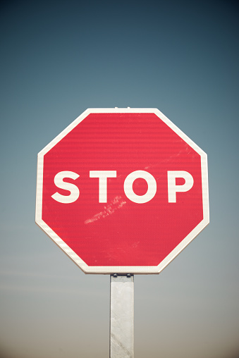 Close-up of stop sign and clear blue sky