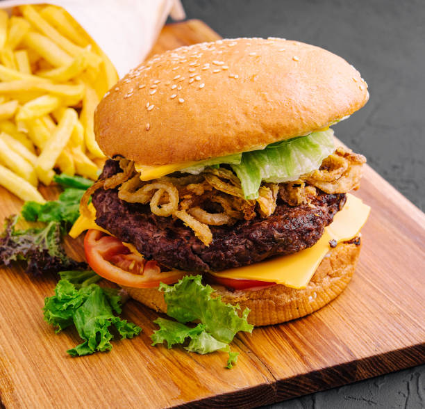 istock burger with onion chips and fries 1481329038