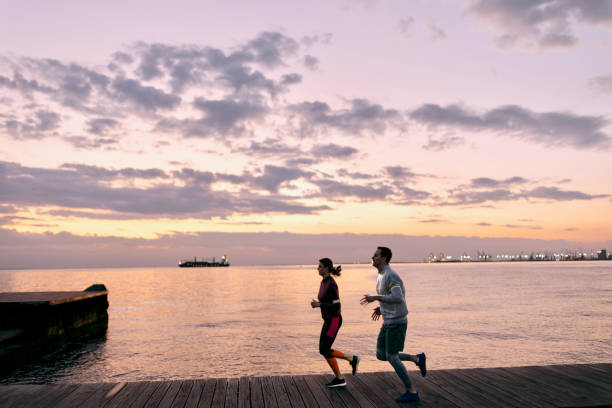istock Two persons running by the seaside at night 1481330373