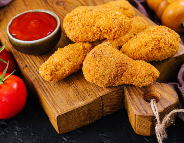 istock Fried chicken with ketchup on a wooden board 1481330587