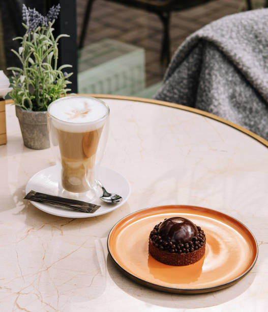 istock Latte coffee with cake on the table in the outdoor cafe 1481330911