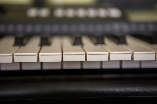 A closeup of the black and white electric piano keyboard