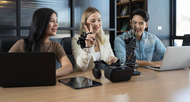 istock Young male and female working with AI robot arm system project in workshop. Male engineer using laptop computer for training Programmable logic controller robotics arm system project 1481335574