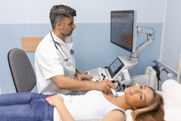 cancer prevention. health and medicine. patient woman from the endocrinologist for thyroid gland ultrasound. young woman doing neck ultrasound examination at hospital - ultrasound cancer healthcare and medicine thyroid gland imagens e fotografias de stock