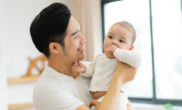 istock image of asian father and son at home 1481336028