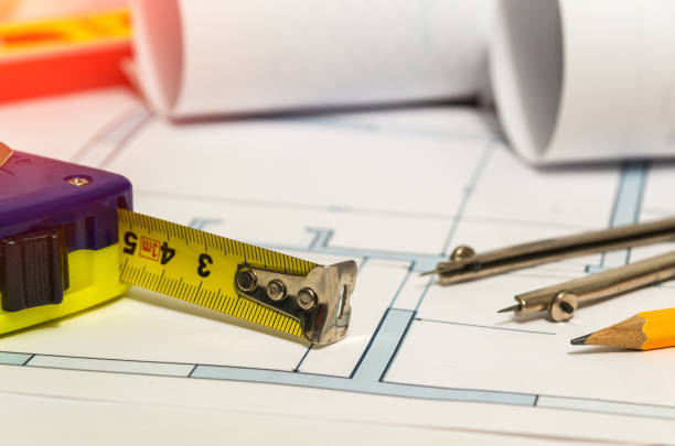 istock Construction tape and divider on the drawings before designing the house. Work environment of a builder 1481336152