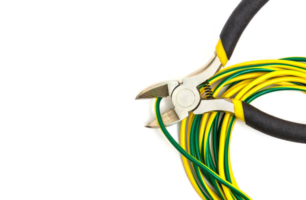 Wire cutters or diagonal pliers and wires close up on white background.