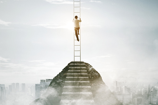 Businessman climbing stairs - Career development and success concept