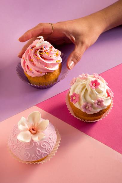 istock Woman reaching out to take cupcakes 1481338472