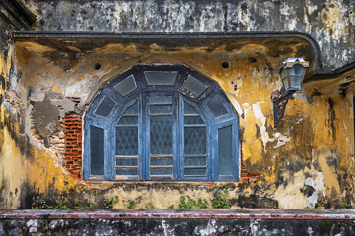 Dilapidated vintage windows of an old Chinese shop house in the heritage town of Georgetown in Penang, Malaysia.