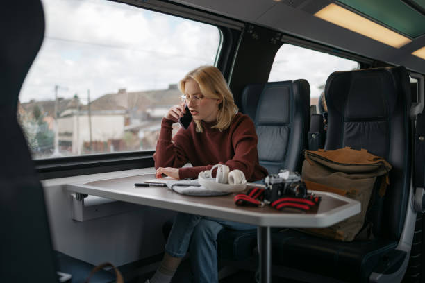 istock Young female tourist communicating over mobile phone while traveling by train. 1481341641