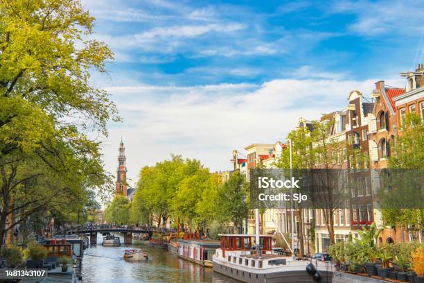 Amsterdam Canal With House Boats And Merchants Houses In The Downtown Canal District During Summer Stock Photo - Download Image Now