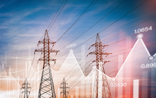 high-voltage power lines against the backdrop of the sunset sky with graphs of electricity consumption statistics