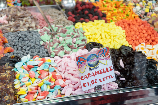 Piove di Sacco, Veneto, Italy - Apr 11th, 2023: Counter of a candy store full of candies with a price sign