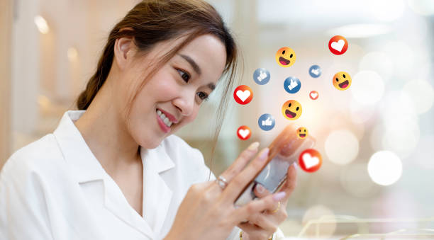 istock woman using smartphone with social media icons. 1481347287
