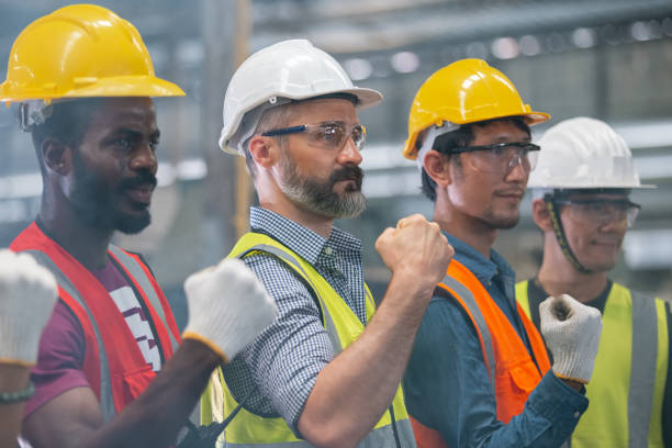 istock group of engineer professional successful team corporate workers standing in factory. 1481347382