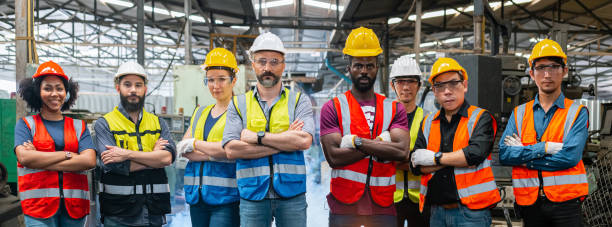 Group of various nationalities engineer professional successful team corporate workers standing in factory. teamwork technician inspector manufacturing industry workplace. Full team heavy industrial factory concept.