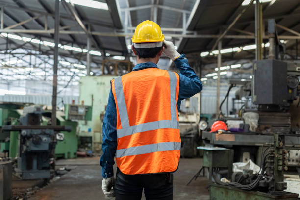 istock View from behind. man engineering wear uniform industry contractor in factory. 1481347984