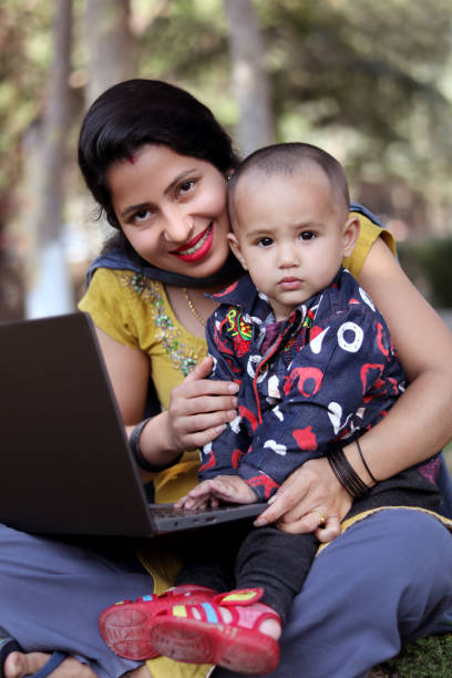 istock Women using laptop with baby daughter 1481349040