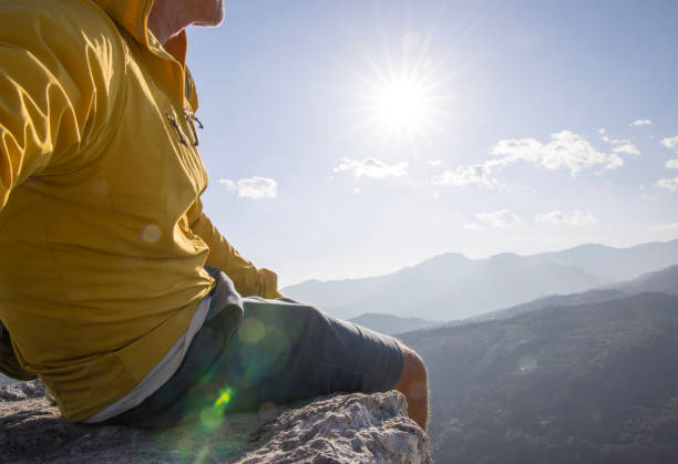 istock Senior hiker relaxes on summit and looks out 1481351451