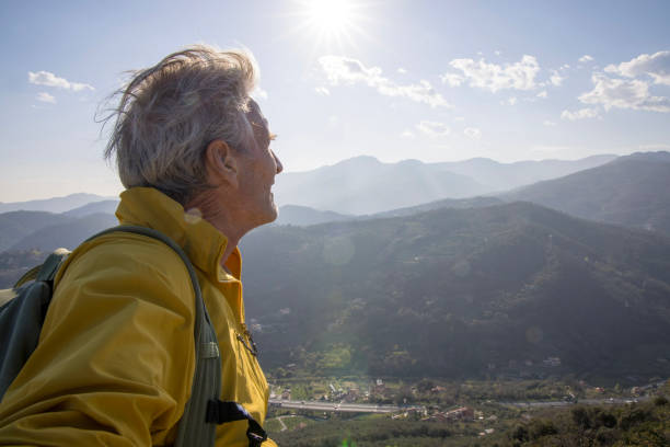 istock Senior hiker relaxes on summit and looks out 1481351570