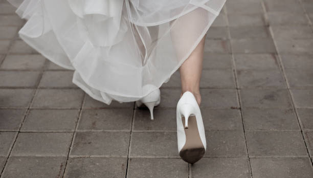 istock Bride's legs in stylish high heels 1481351707