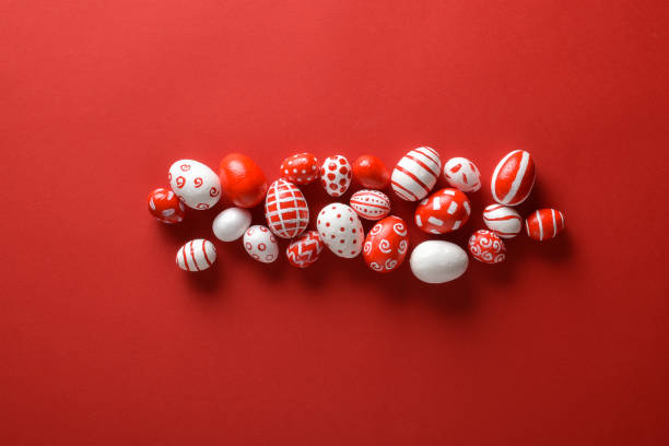 istock Easter backgrounds. Easter red and white eggs on bright red in the center on a red background. 1481351943
