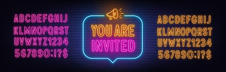 You Are Invited neon sign in the speech bubble on brick wall background . Pink and yellow neon alphabets