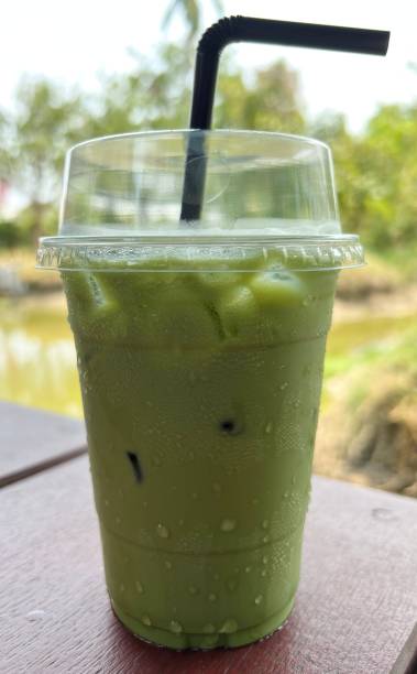 istock Iced Green Tea in take away cup isolated on black background. 1481353551