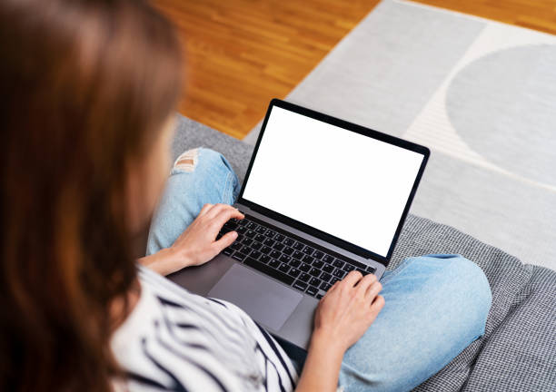 istock Laptop with blank screen on females lap. 1481354334