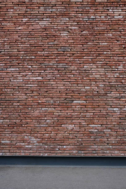 Vertical photo old decorative wall made of red bricks. Template for design.