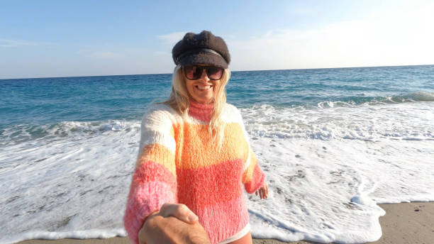 istock POV of woman pulling man onto beach 1481356859