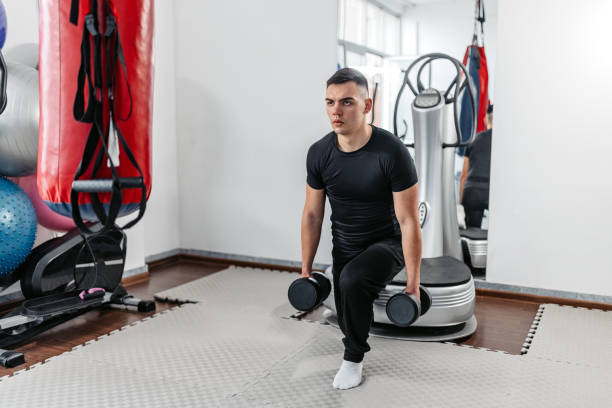 istock Young Man Training With Dumbbells At The Gym 1481357340