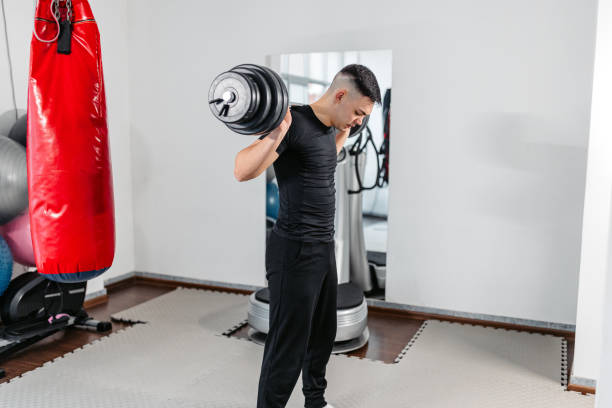 istock Young Man Lifting Weights At The Gym 1481357354