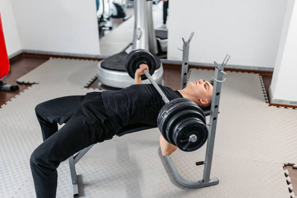 istock Young Man Lifting Weights At The Gym 1481358067