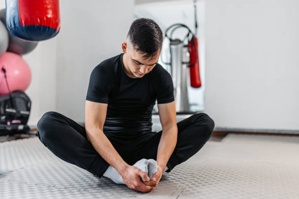 istock Young Man Stretching Before Working Out At The Gym 1481358226