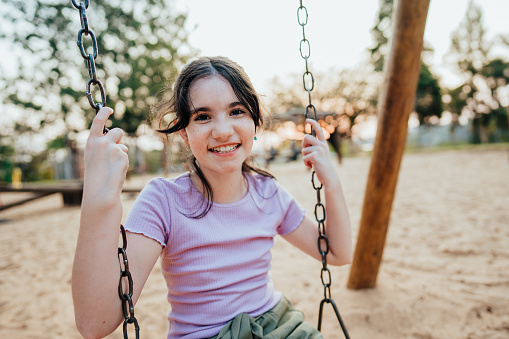 Portrait of a child swinging on the playground