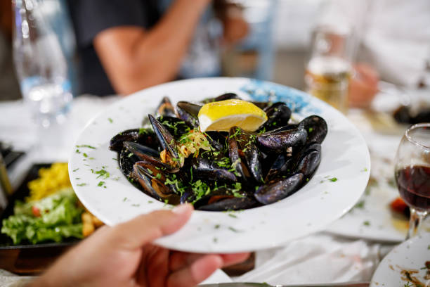 A plate of mussels at the dinner party stock photo