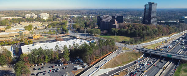 istock Panorama view busy traffic on The Perimeter Interstate 285 highway, elevated expressway, office buildings lush greenery Murphey Candler Park background, midtown Atlanta, Georgia 1481361455