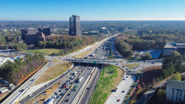 istock Busy traffic along The Perimeter or Interstate 285 highway, elevated expressway, office buildings with lush greenery Murphey Candler Park background, midtown Atlanta, Georgia 1481361495
